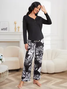 Two-piece women's pajama set with black long-sleeve henley top and floral print pants