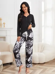 Women's floral pajama set featuring a long sleeve black top and stylish printed pants