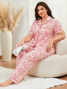 Model in plus size pajamas set with red heart print lounging in a cozy living room
