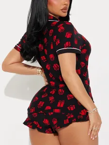 Detailed view of women's black festive pajama set featuring all-over red gift box prints