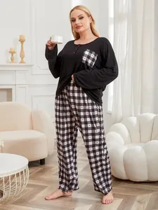 Plus-size women pajama set with black long-sleeve top and heart-pattern plaid pants in home