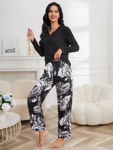 Elegant women's loungewear set with black long sleeve top and floral print pants