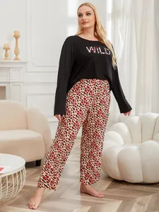Detailed view of plus size two-piece pajama set with WILD print top and leopard pants.