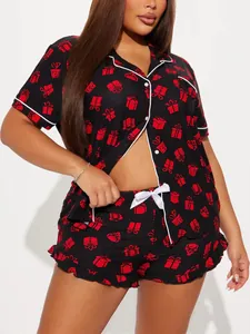Close-up of black women's pajamas with red gift box print and white piping detail