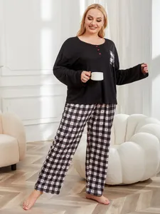 Plus size women's pajama set featuring black top and heart-patterned plaid pants