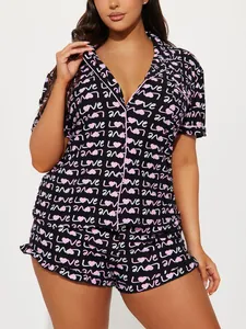 Close-up detail of women's heart print short-sleeved pajama set in black and pink