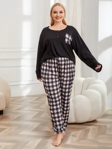 Plus size women's two-piece pajama set featuring black long-sleeve top and plaid heart pants
