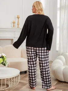 Plus size women's loungewear set featuring black long sleeve top and heart plaid pants