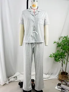 High-quality detail view of grey short-sleeve pajama set with embroidered pocket