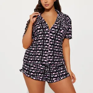 Women's two-piece heart print pajama set with short sleeves and shorts in black and pink