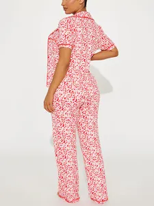 Rear view of pink heart print plus size pajamas set with short sleeve top and long pants.