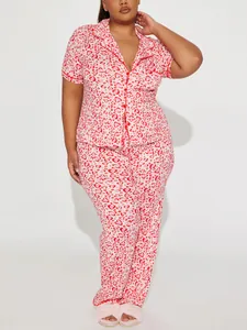 Detailed view of plus-size women's pajama set featuring vibrant red and pink heart patterns