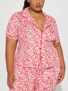 Detailed view of a comfortable women's plus size pajama set with pink heart print.