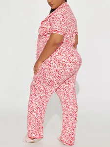 Plus size women's two-piece heart print pajama set shown from a side profile view.