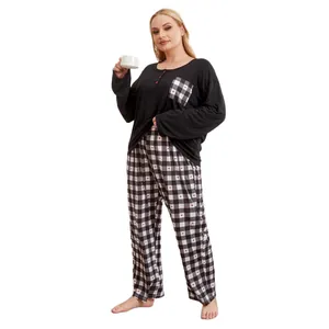 Plus size women's pajama set featuring black long sleeve top and plaid heart print pants