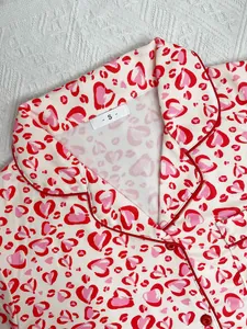 Close-up detail of women's heart leopard print pajama collar featuring red piping finish