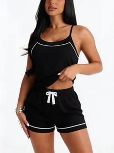 Close-up of a sexy black nightwear set featuring a camisole and shorts with white piping