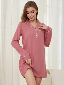 Full length view of a soft pink long-sleeved nightgown with elegant white piping details