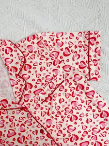 Detailed macro view of red heart leopard print fabric on women's soft pajamas set