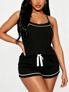 Detailed shot of black camisole pajama set with white contrast piping for women