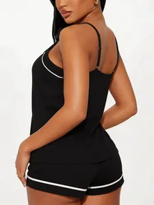 Rear view of a stylish black two-piece pajama set with elegant white piping details