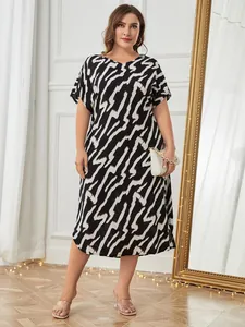 Full length view of a plus-size short-sleeved nightgown with bold black and white print