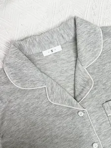 Close-up of grey marl pajama top collar with white piping and size S label