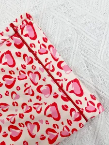 Close-up of heart leopard print fabric with red piping detail for women's pajamas