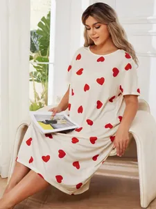 Detailed view of cream heart-print plus-size nightgown on model