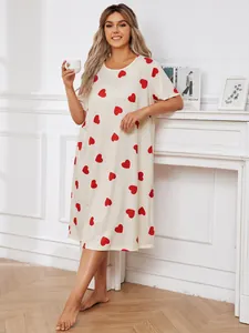 Detailed view of cream-colored plus-size nightgown featuring vibrant red heart prints.