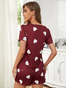 Back view of women's burgundy pajamas with white heart print short sleeve and shorts