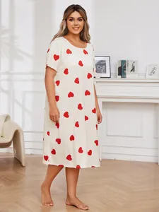 Detailed view of plus size white nightgown with vibrant red heart print and short sleeves