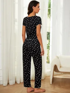 Back view of black heart print pajama set featuring short sleeves and long pants.