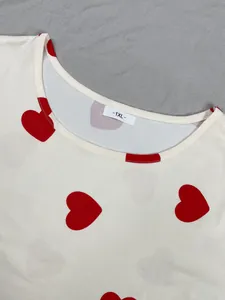 Close-up of plus size nightdress neckline with red heart print and 1XL tag.