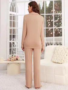 Detailed back view of a women's beige modal pajama set featuring a long-sleeve shirt and pants