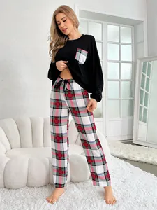 Stylish women's 2-piece pajama set featuring a black long sleeve top and red plaid pants