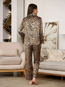 Back view of leopard print satin pajama set featuring long sleeves and pants.