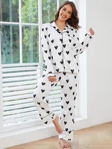 Stylish woman wearing a cozy white heart print pajama set with long sleeve shirt and pants