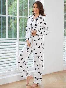 Full view of women's white heart print pajama set with long sleeves and matching pants