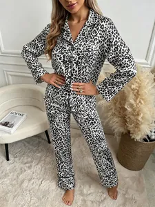 Elegant leopard print silk pajama set featuring a long-sleeved shirt and matching trousers