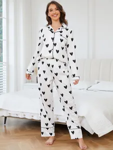 Stylish women's white pajama set with black heart prints, long sleeves and pants