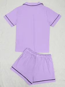 Close-up detail of purple ribbed short-sleeved pajama set with black piping on collar and hem