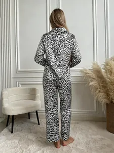 Rear view of women's leopard print satin pajama set featuring long sleeves and pants