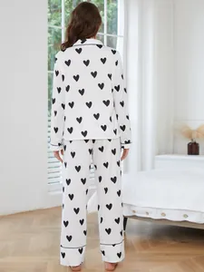 Back view showing the full silhouette and black heart pattern of this pajama set.