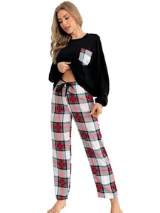 Comfortable two-piece pajama set featuring a black long-sleeve top and red plaid pants detail