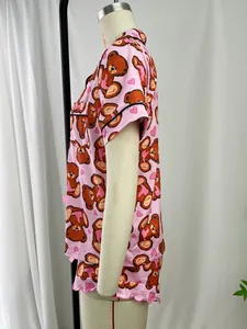 Side view of pink cartoon bear pajama set with short sleeves and button-up collar