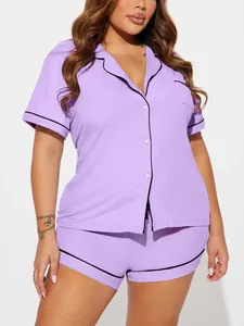 Detailed view of women's purple ribbed pajama set with black trim and button-down shirt