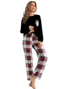 Full view of women's comfortable two-piece pajama set with black top and plaid pants