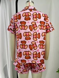 Detail view of the pink cartoon bear pajama set back design on a mannequin
