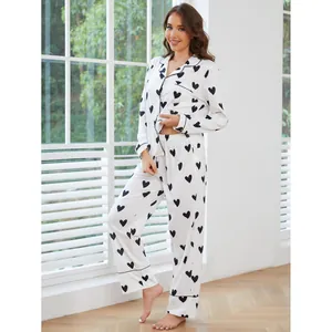 Cozy two-piece white pajama set for women featuring black heart prints and long pants